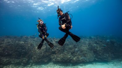 Two divers demonstrate excellent underwater buoyancy