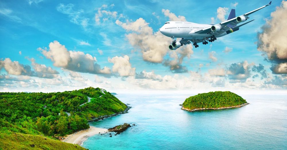 An airplane flying over a tropical island where divers know flying after diving is only safe after a long surface interval