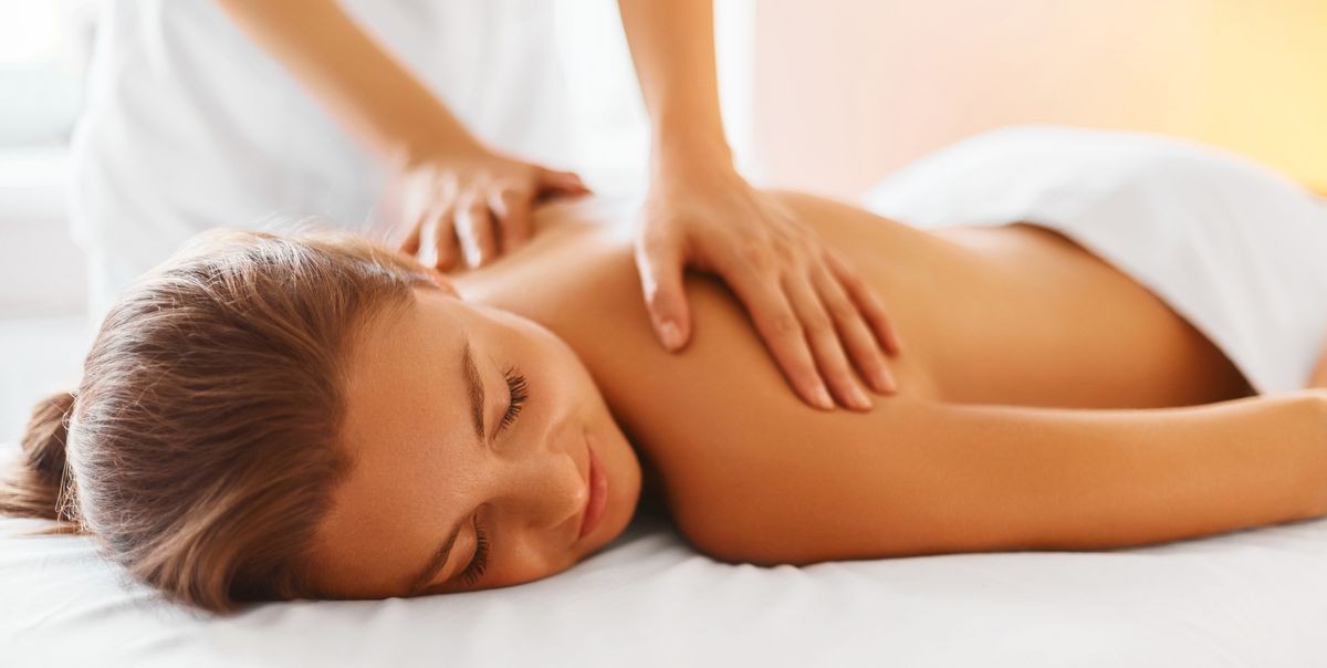 A woman gets a deep tissue massage at a spa, a relaxing treatment that should not be done too soon following a scuba dive
