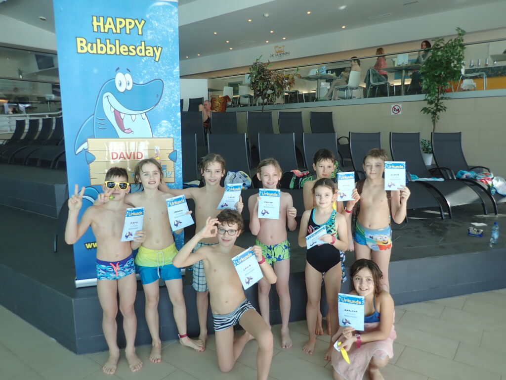 At a Kids scuba birthday party children smile and hold certificates.