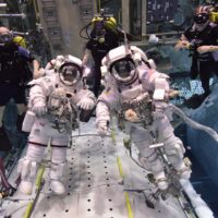 NASA astronauts with scuba divers in a pool