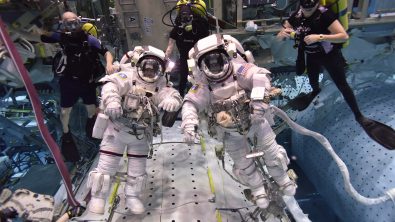 NASA astronauts with scuba divers in a pool