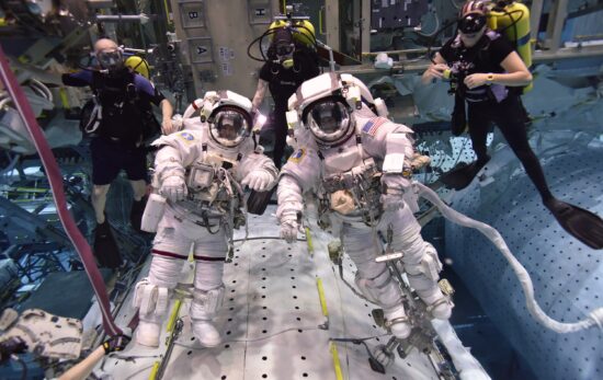 NASA astronauts with scuba divers in a pool