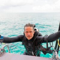 Fabien Cousteau climbs a dive boat ladder