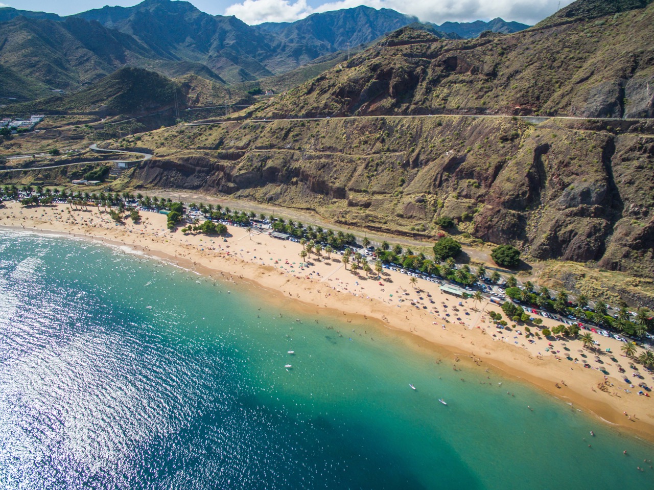 A beach beneath the mountains in the Canary Islands, Spain, which is one of the best places to learn to scuba dive in Europe