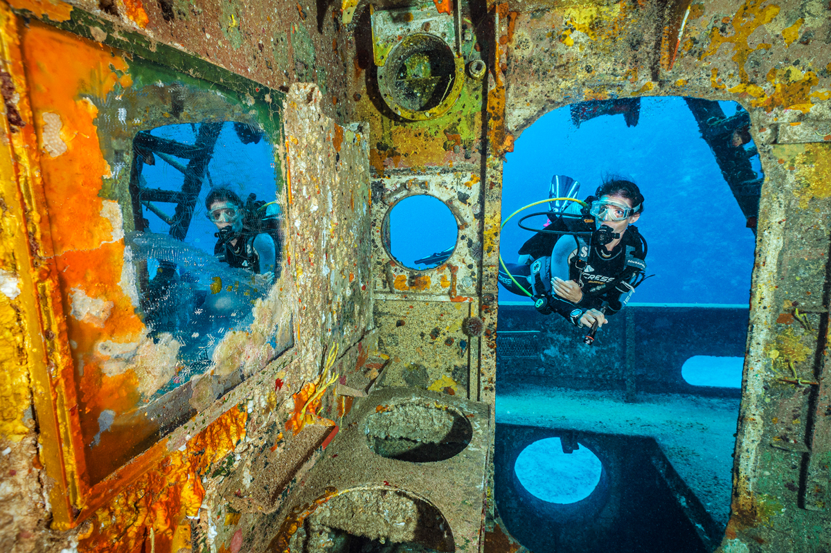 A scuba diver looking inside a wreck