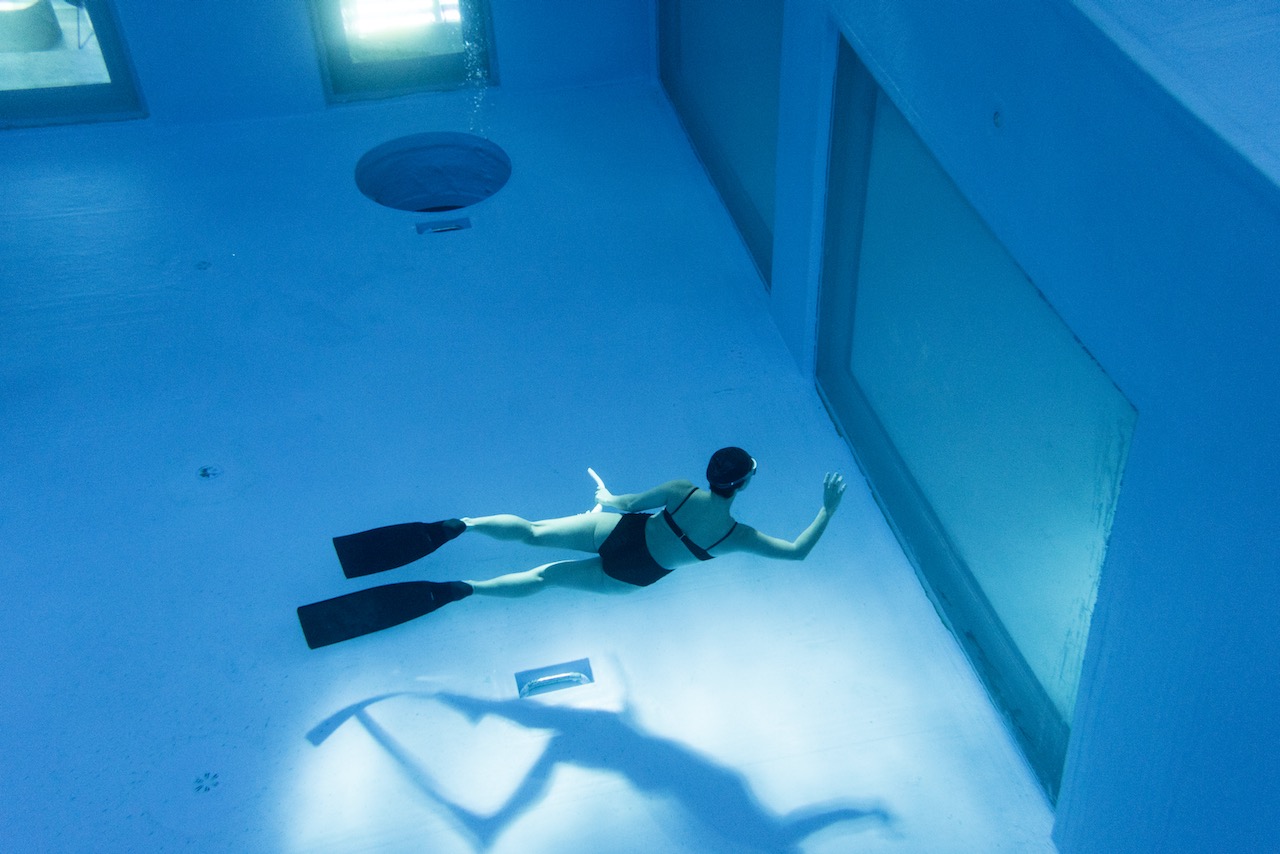 A freediver peering through one of the large windows at K-26 in South Korea