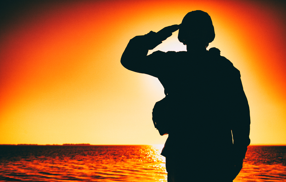soldier saluting ocean sunset