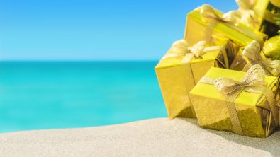 a tropical ocean with gift boxes in the foreground. scuba courses are giftable