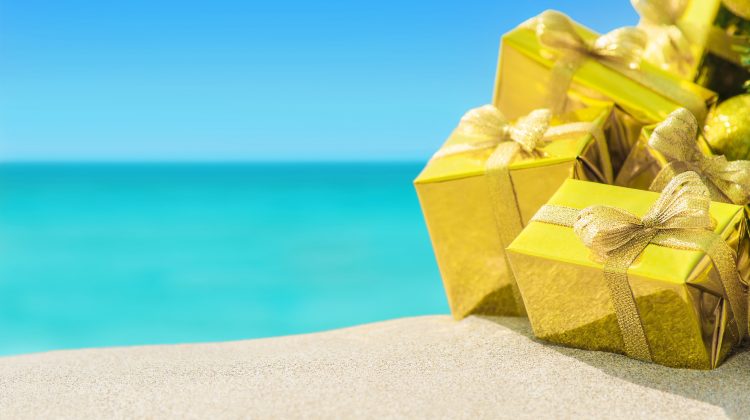 a tropical ocean with gift boxes in the foreground. scuba courses are giftable