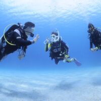 Instructor and student diver communicating with hand signal underwater