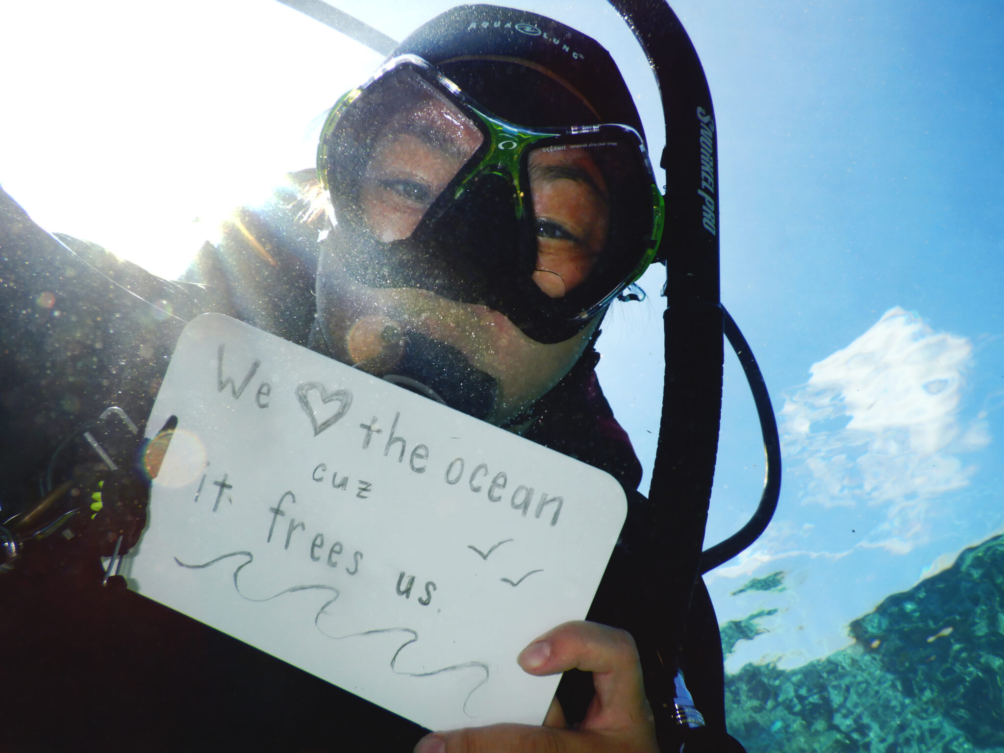 Diver holding a sign that says 