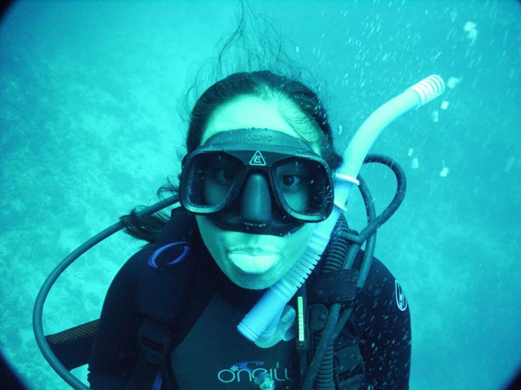 a diver sticking their tongue out underwater