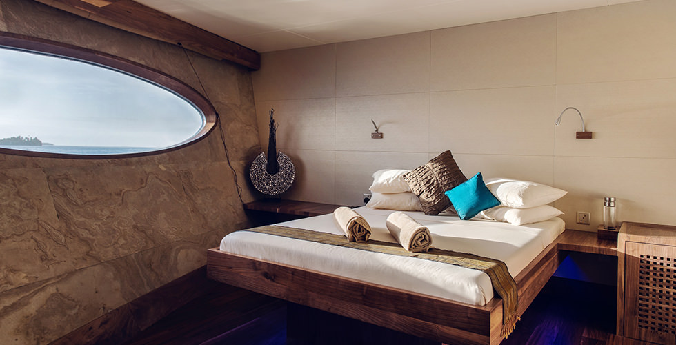 A pristine bedroom in the cabin of a luxury spa liveaboard and the focus of many questions about liveaboard diving and travel