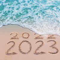Message Year 2022 replaced by 2023 written on beach sand background. Good bye 2022 hello to 2023 happy New Year coming concept.