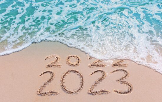 Message Year 2022 replaced by 2023 written on beach sand background. Good bye 2022 hello to 2023 happy New Year coming concept.