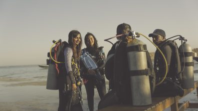 four divers exit the water after a shore dive in the Red Sea, Egypt