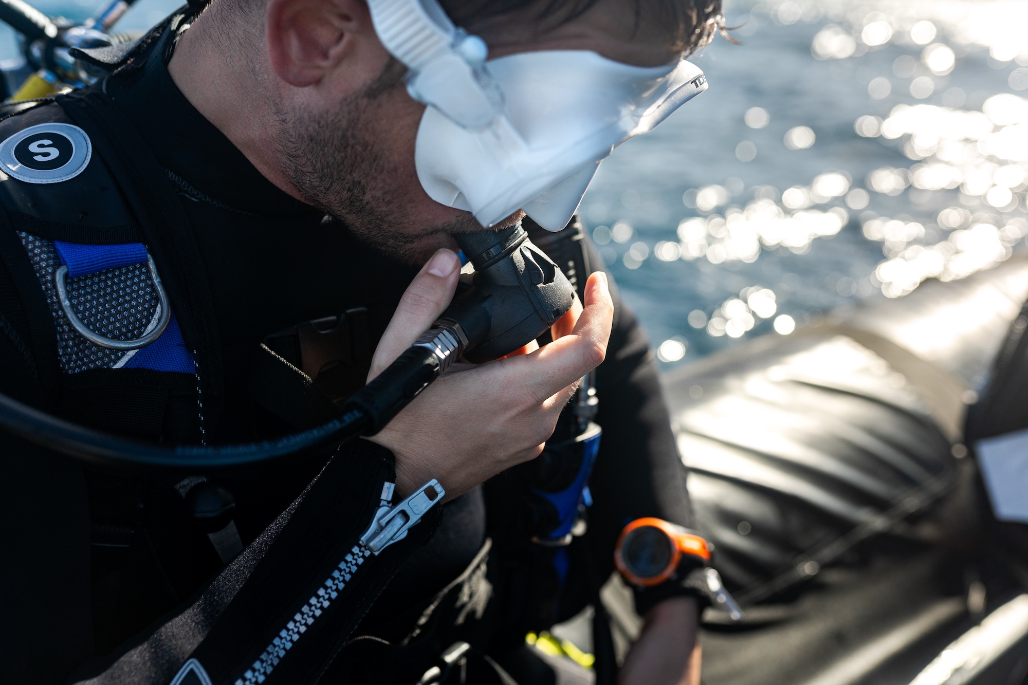diver checking their equipment on boat