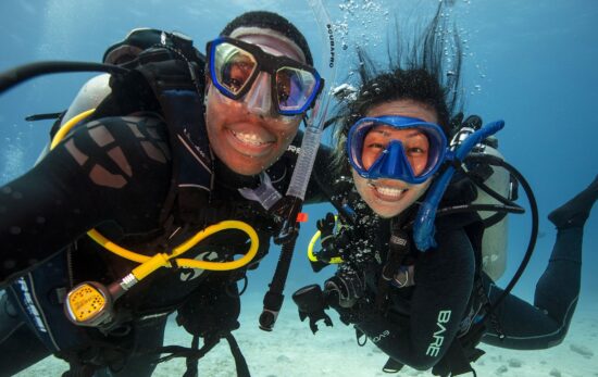 Two smiling divers underwater