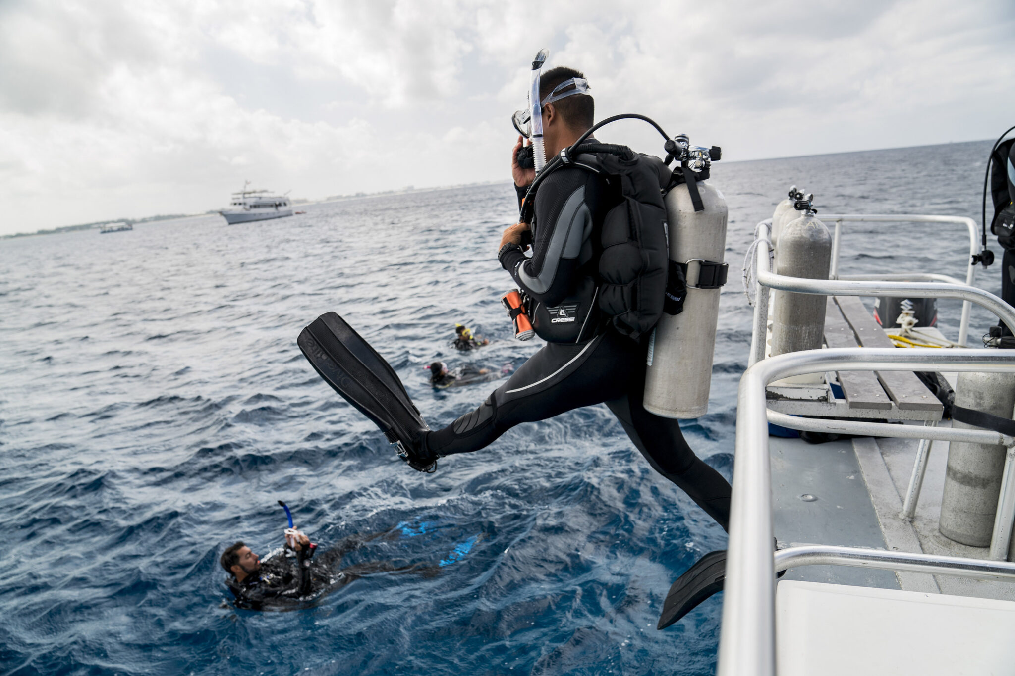 A scuba diver making a giant stride entry from a boat