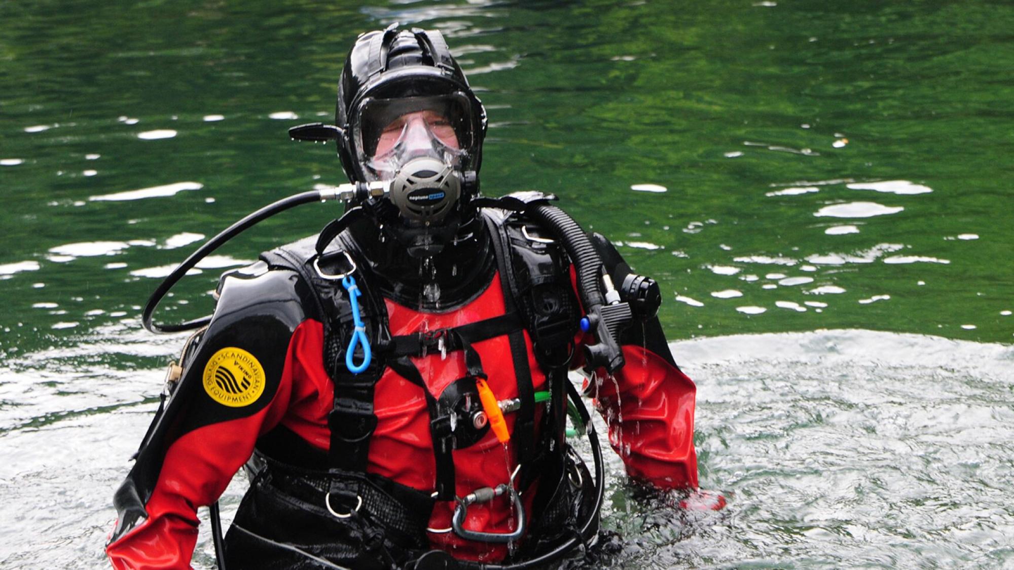 A public safety diver wearing a drysuit and who undertakes underwater investigation work including search and recovery jobs