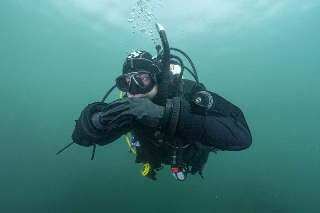 a diver in cold water wearing a dry suit