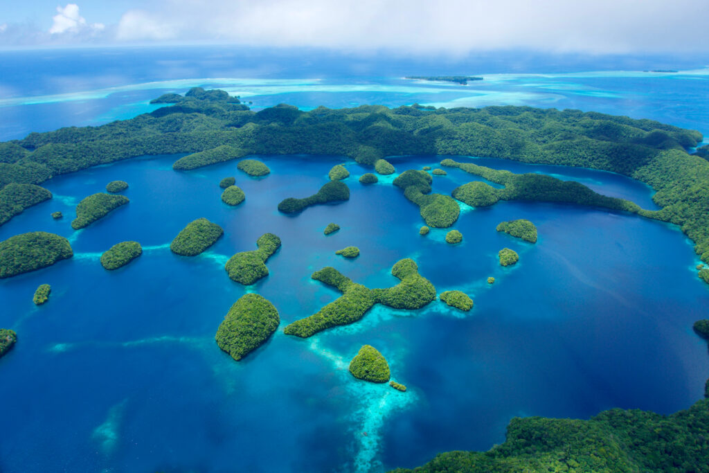 An aerial view of lush green islands tucked among blue bays