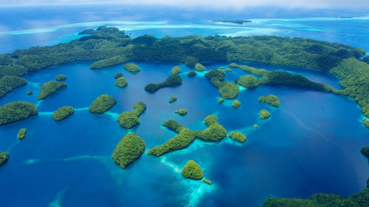 An aerial view of lush green islands tucked among blue bays