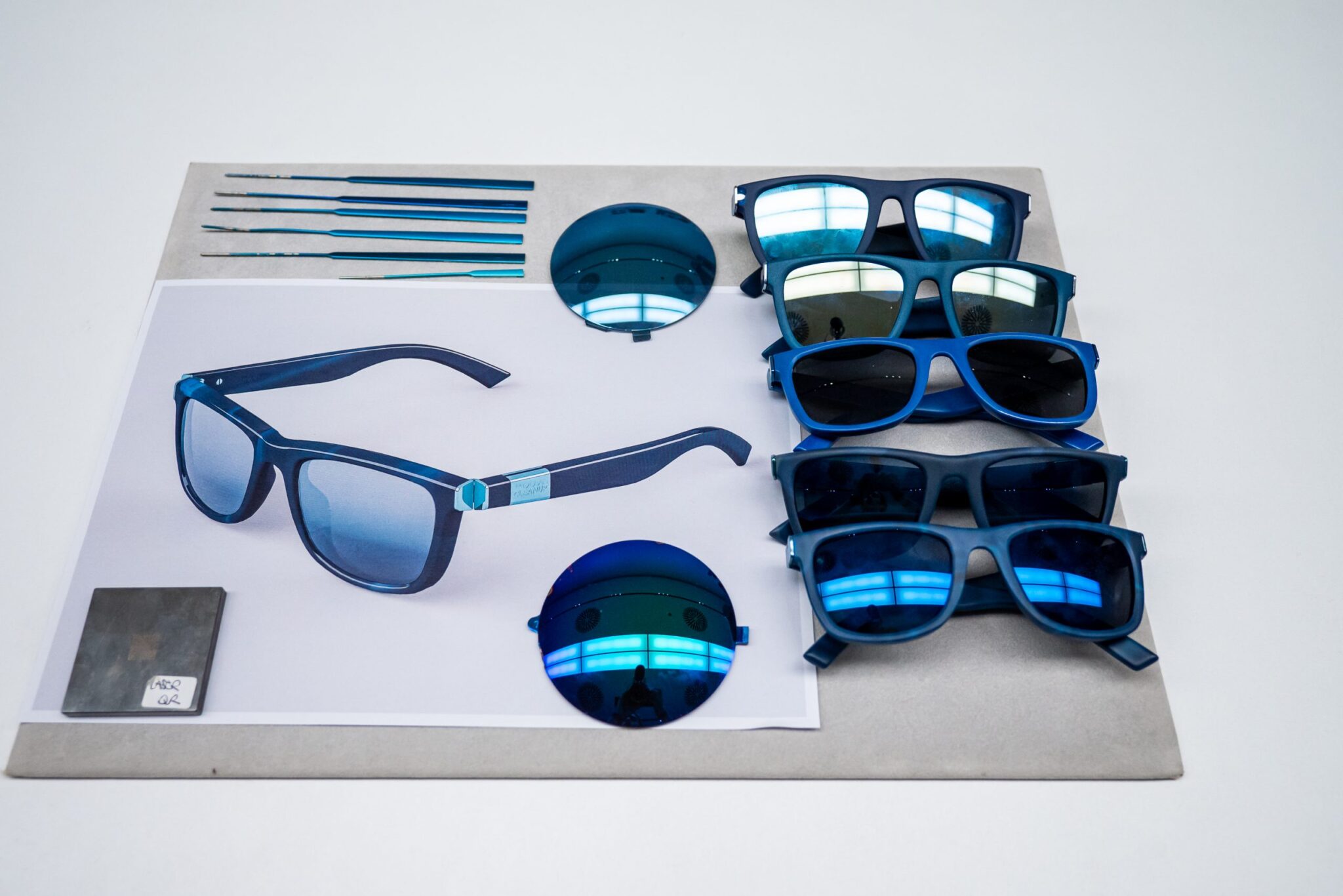 Sunglasses in various shades of blue are displayed. They are made of recycled marine plastic.