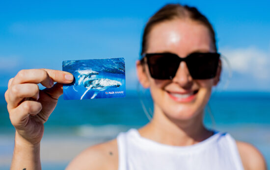 a woman holds a padi certification card