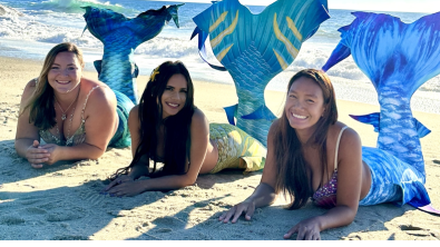 Elle Jimenez, Elaina Thomas, and Great Chin Burger posing on a beach
