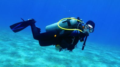 a scuba diver underwater looking directly at the camera