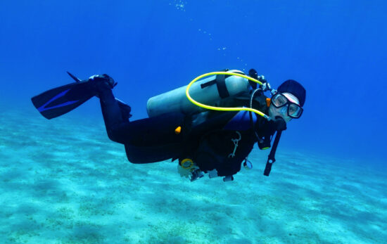 a scuba diver underwater looking directly at the camera