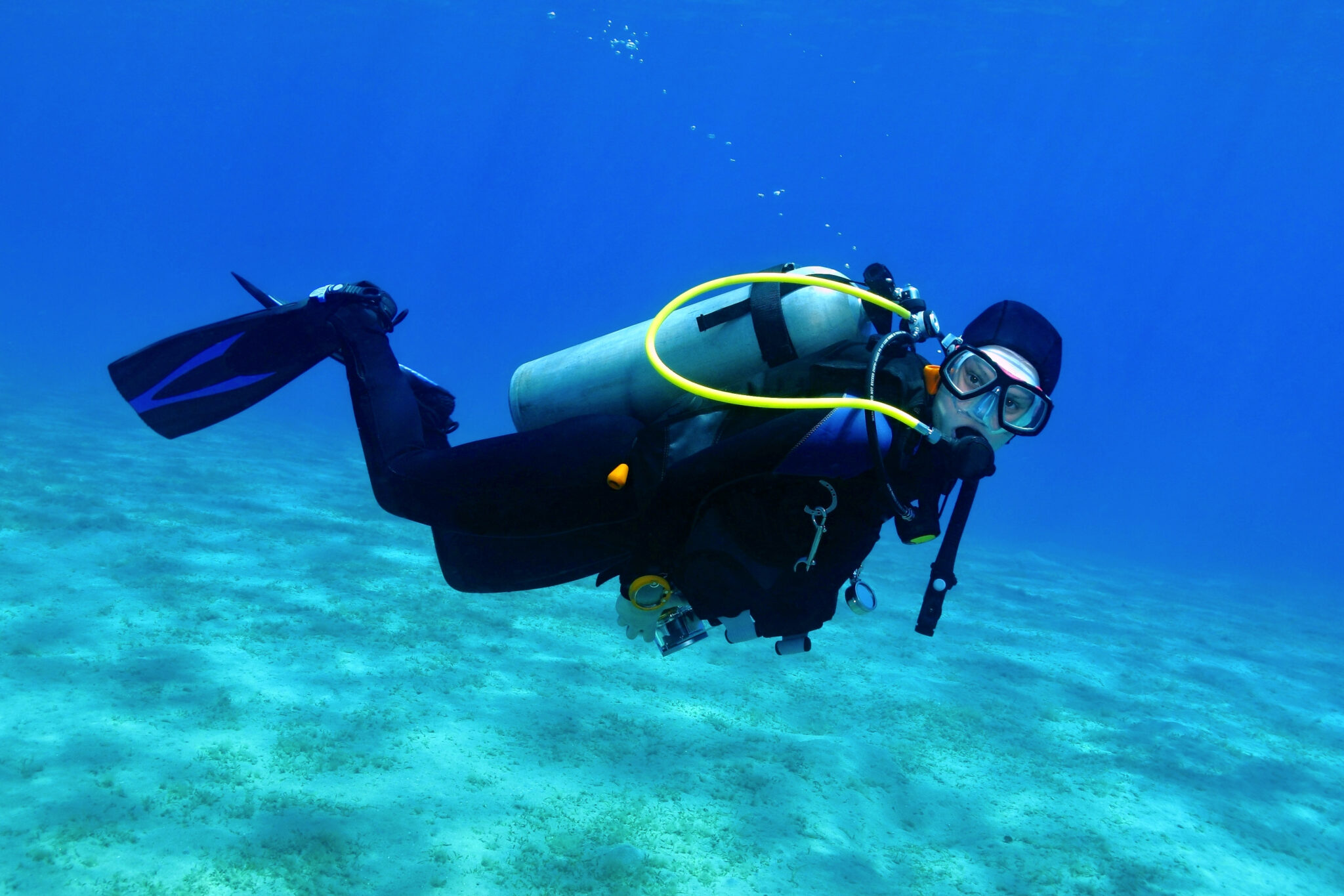 a scuba diver underwater looking directly at the camera