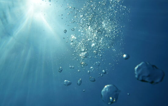 bubbles rising to the surface of the ocean