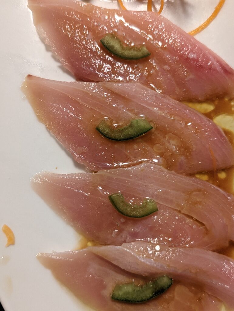 Sashimi slices with jalapeno, close up, with ponzu sauce at Sandals Resorts.