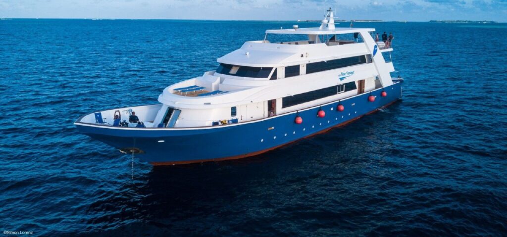 A blue and white scuba diving liveaboard boat in the maldives