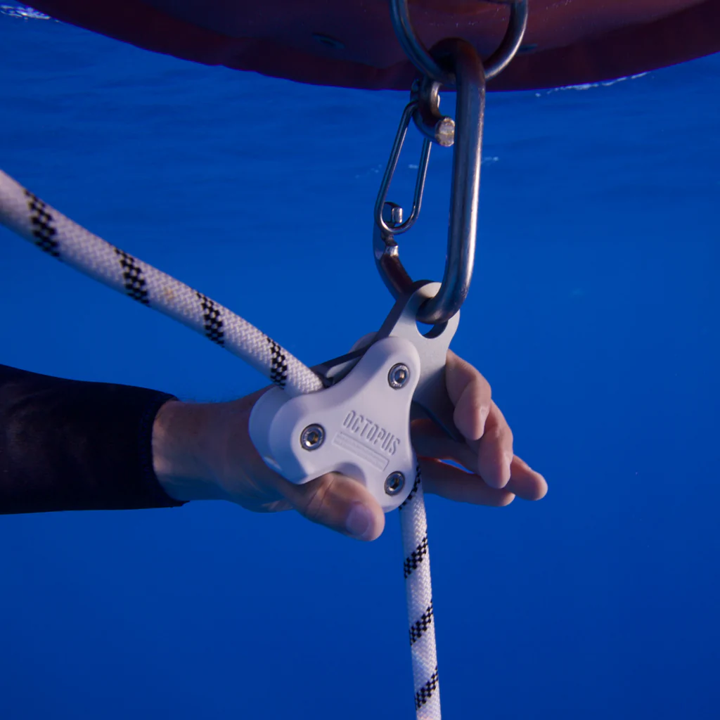 a freediver using the ocotpus pulling system to raise a line underwater