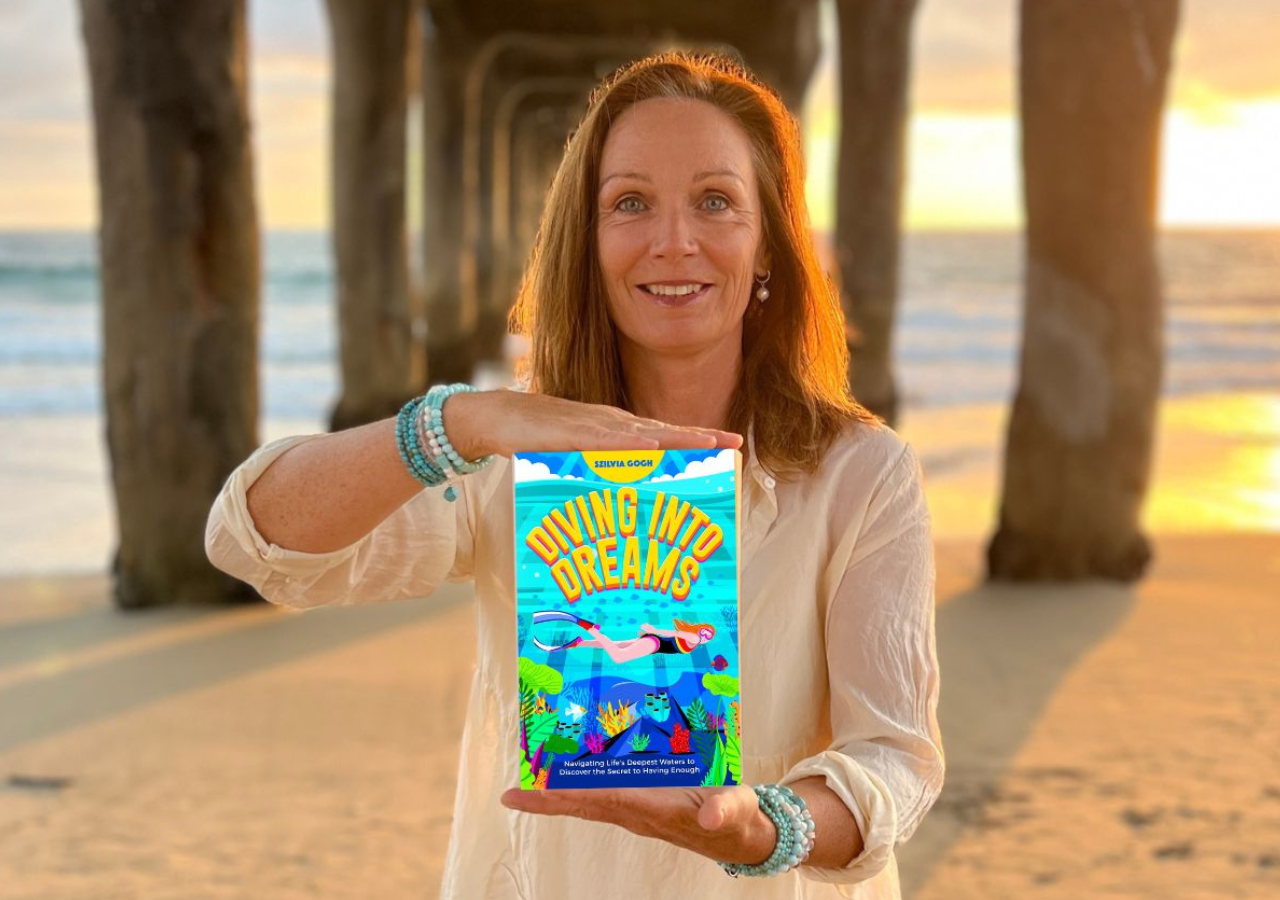 szilvia gogh holding her book under a pier
