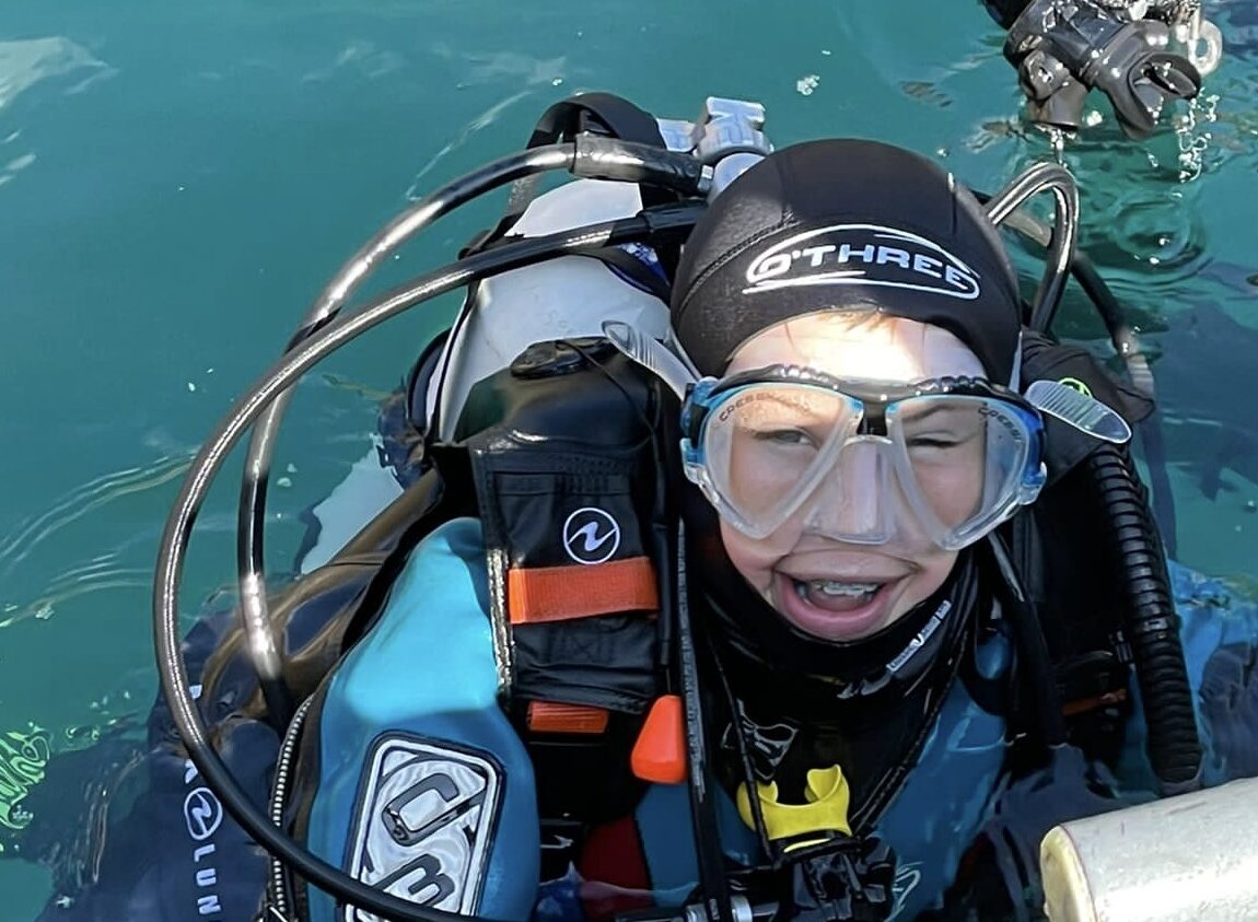 Ollie Krestovnikoff smiling on the surface after a scuba dive where he has learned how to build connections underwater