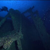 A diver floats over the deck of the Brittanic shipwreck near Kea, Greece