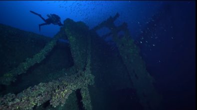 A diver floats over the deck of the Brittanic shipwreck near Kea, Greece