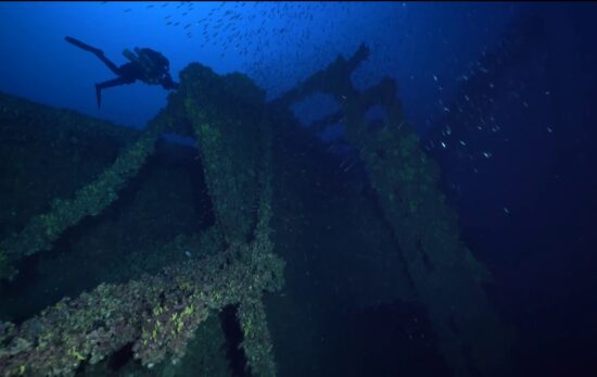 A diver floats over the deck of the Brittanic shipwreck near Kea, Greece