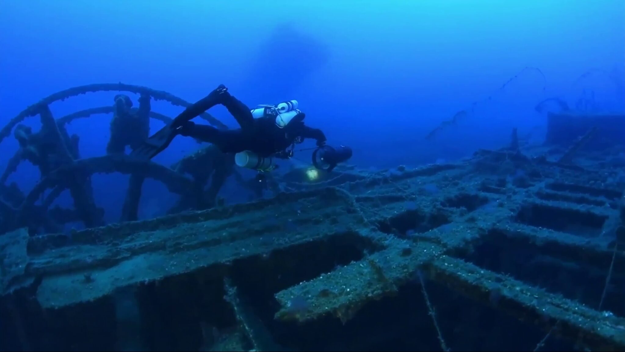 A scuba diver floats over the Patris shipwreck in Kea, Greece