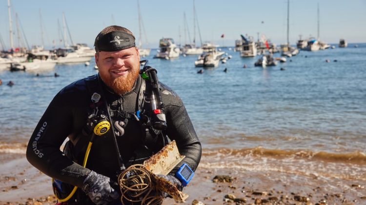A diver exits the water with garbage found during a dive off Catalina Island, California