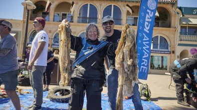 Divers showing plastic debris after underwater cleanup in Catalina