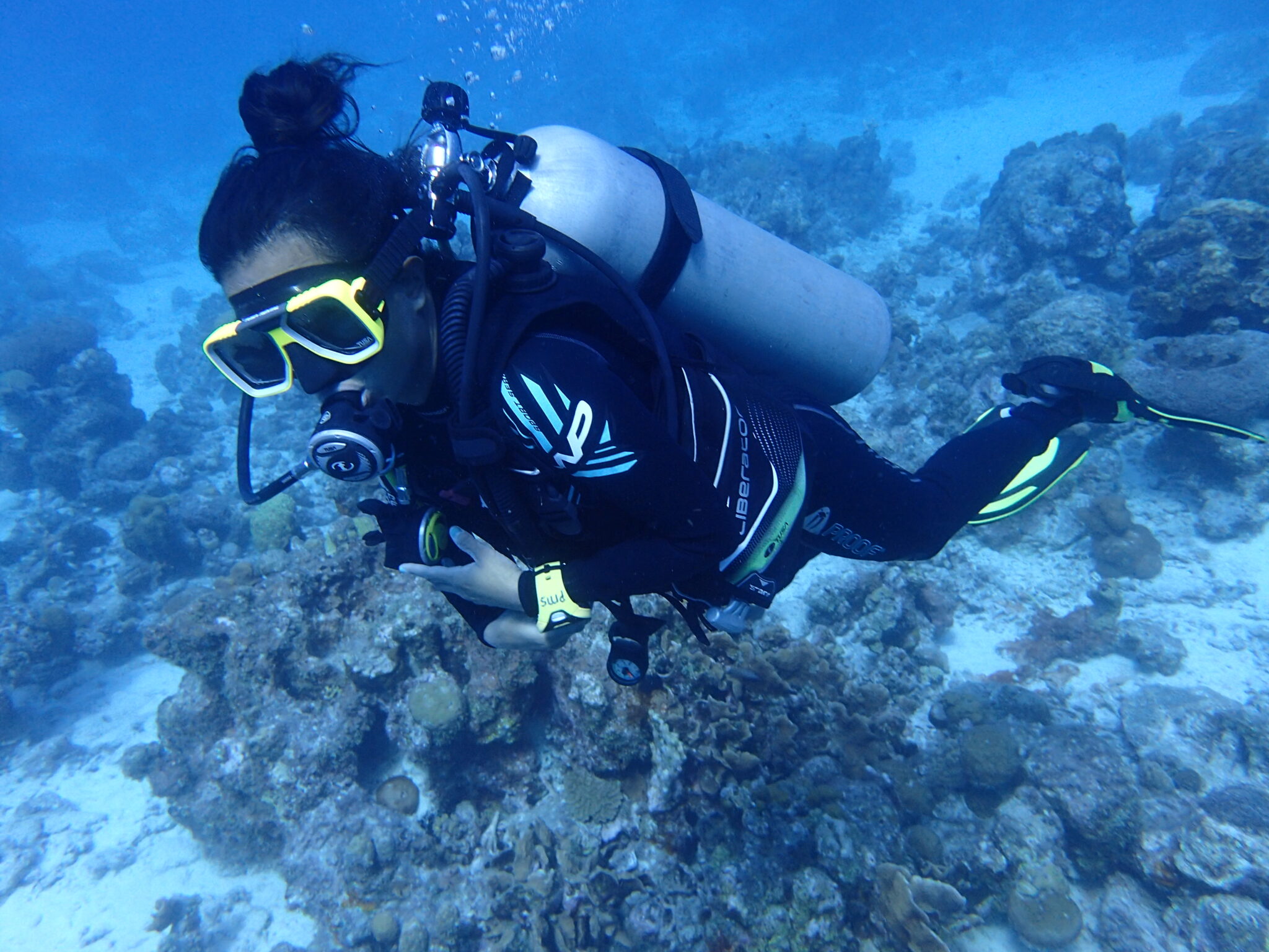 A diver hovers over the sea floor in Curacao on her open water dive.