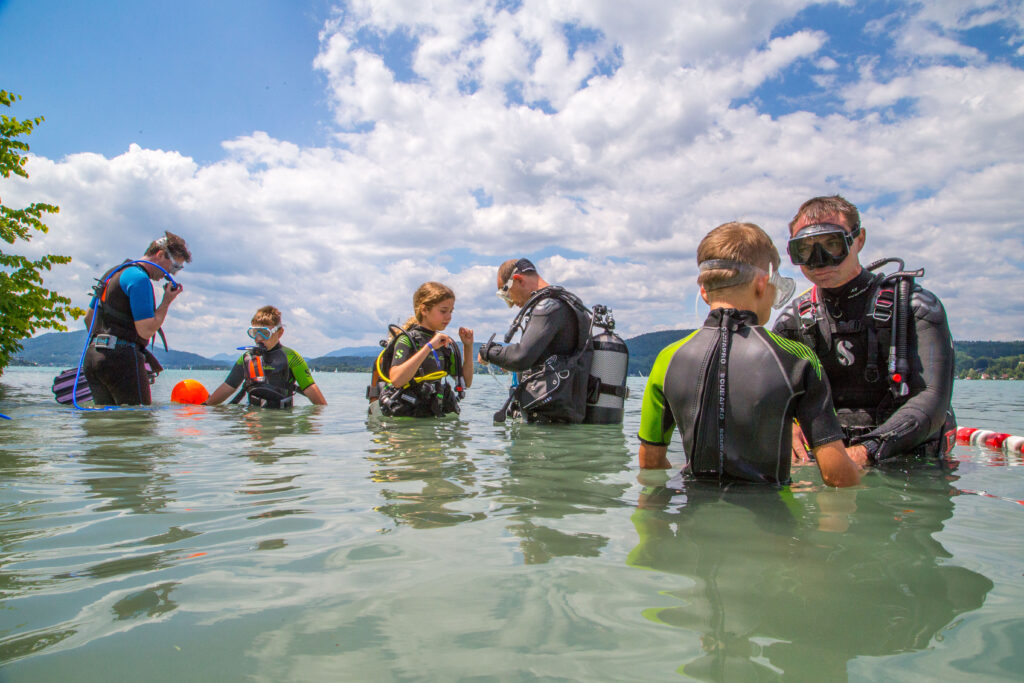 A group of people goes diving in Karnten in Austria