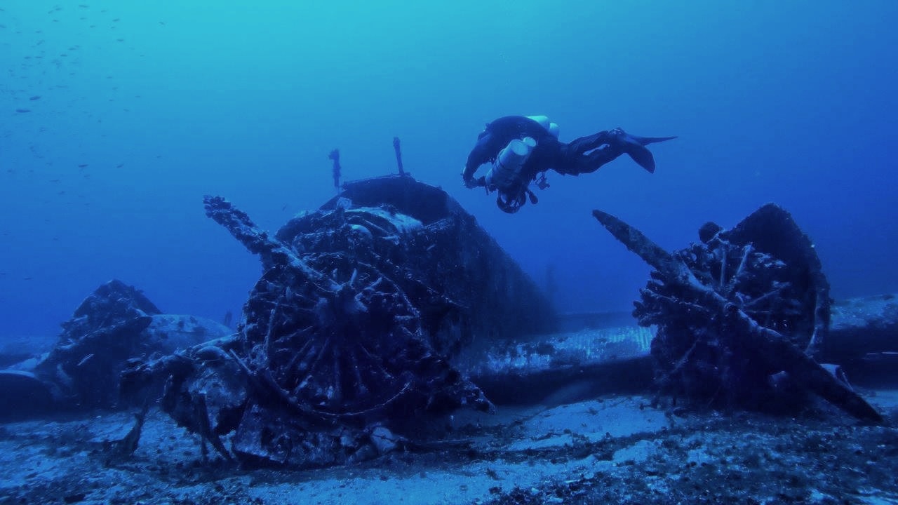 a technical diver explores an airplane wreck from WWII in Greece