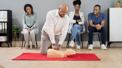 A group of students practice cpr on a dummy
